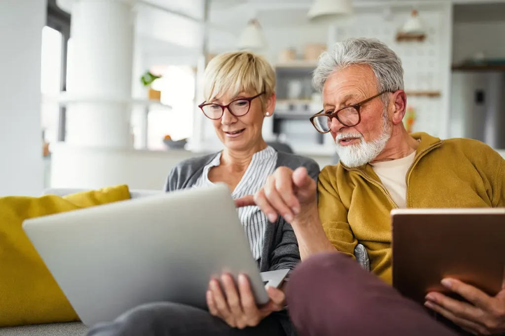 Older couple using laptop at home, RB Wealth financial planning Charlotte NC