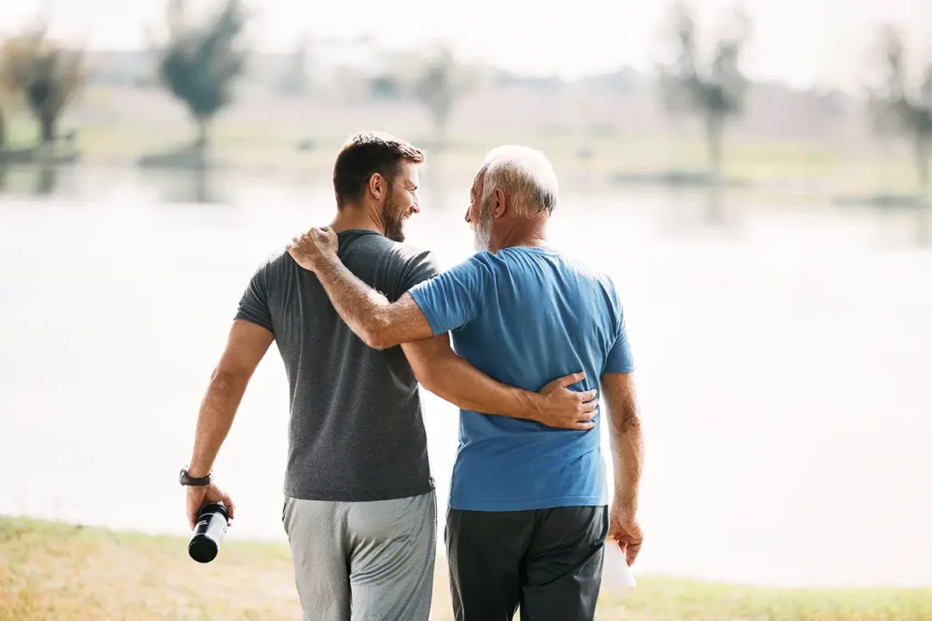 Father and adult son walking together outdoors, RB Wealth retirement planning Charlotte NC