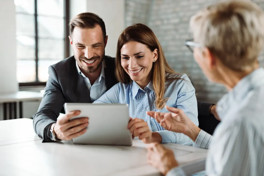Couple meeting with financial advisor using digital tablet, RB Wealth Charlotte NC