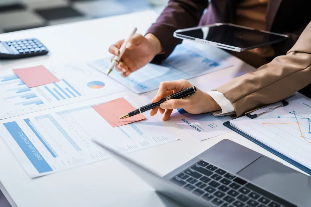 Financial advisor reviewing charts and investment reports with clients, RB Wealth Charlotte NC