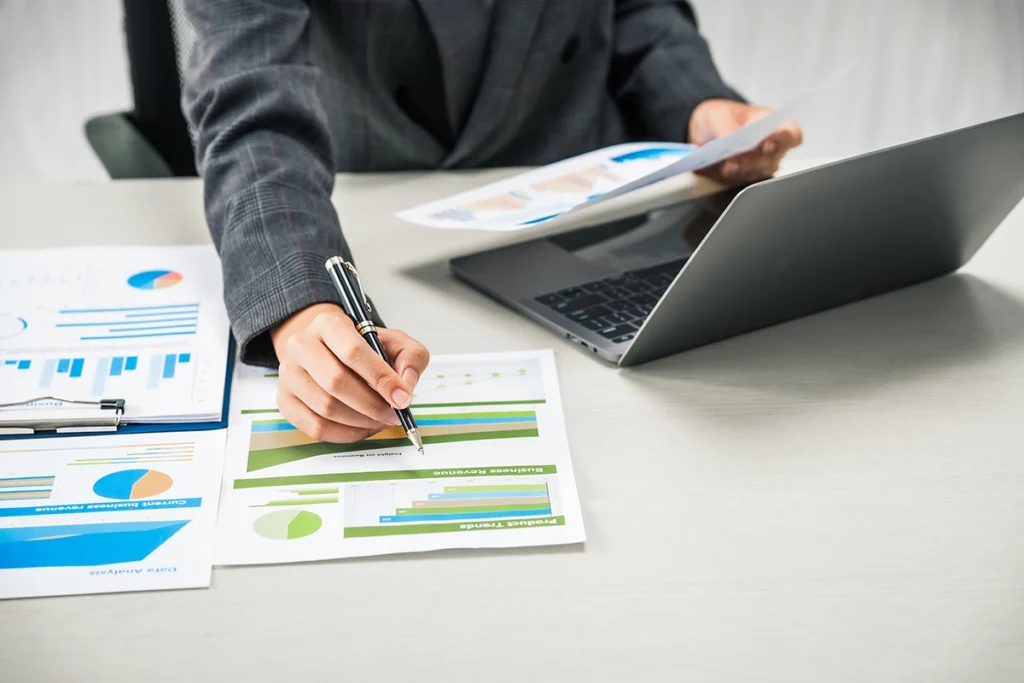Person reviewing investment growth charts and financial goals for long-term wealth building