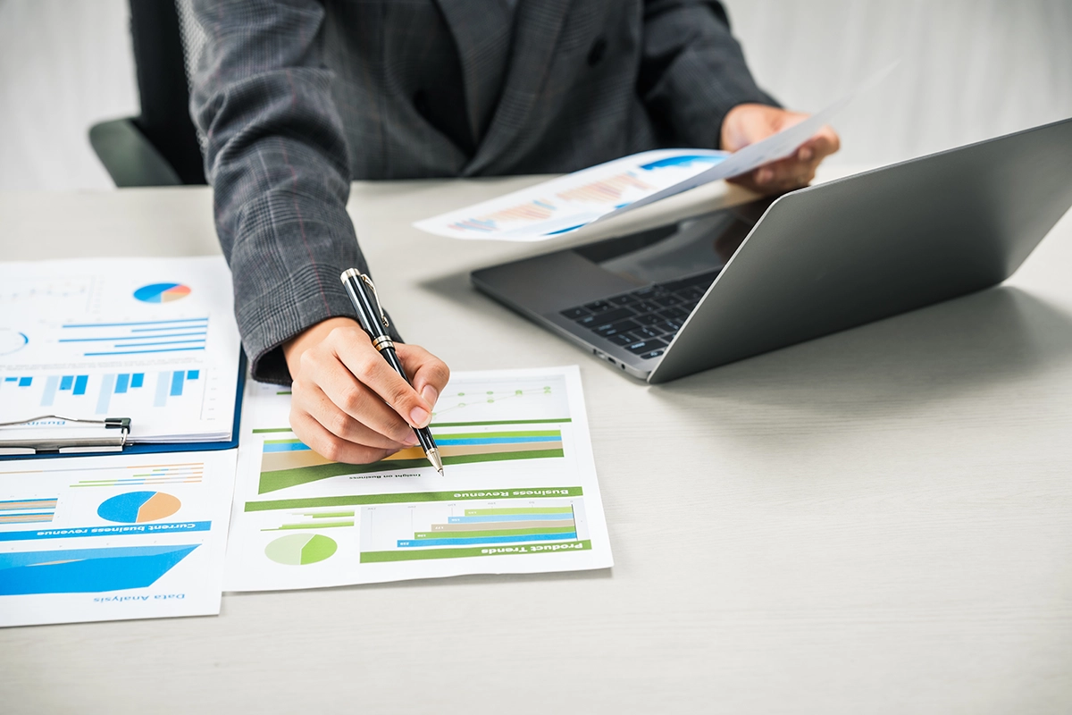 Person reviewing investment growth charts and financial goals for long-term wealth building
